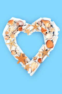 Romantic heart shape wooden white wreath with seashells. Rustic summer driftwood decoration on blue background. Beach treasure symbol of love.