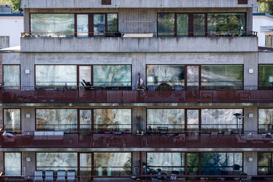 Modern residential apartments with balconies create concrete symmetry across a wide facade as architecture in Stockholm Sweden defines Nordic urban housing