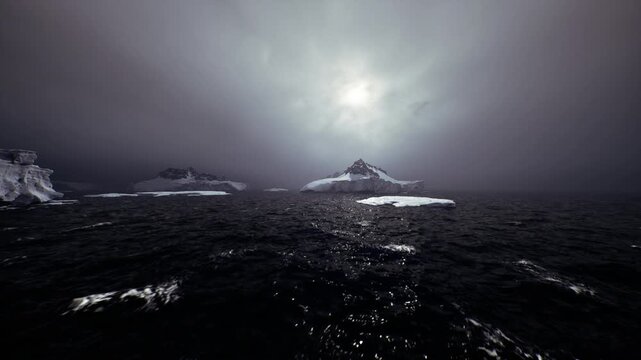 Dark water channel leading toward mountain, shimmering trail of broken ice and reflective ripples, strong sense of passage and maritime route for expedition