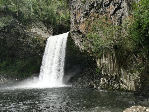 Bassin la paix, scenic waterfall with rocky cliffs with columnar basalt jointing in Saint Benoit, La reunion island.