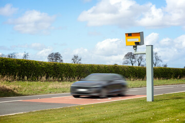 Radar speed camera and fast speeding car on the road © Brian Jackson