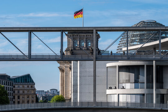 Paul Lobe Haus leads toward the Reichstag parliament dome with architecture government flag and landmark presence in Berlin Germany daylight