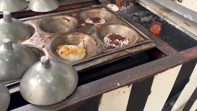 Traditional indonesian pancake serabi being cooked on a metal mold