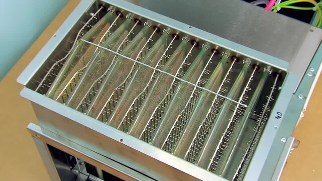 A close-up exploration of an industrial electronic card cage, showcasing its multiple parallel slots and sturdy metallic construction.