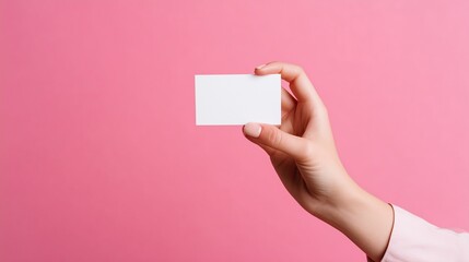 Obraz premium Close-up of a young female hand holding a small white card