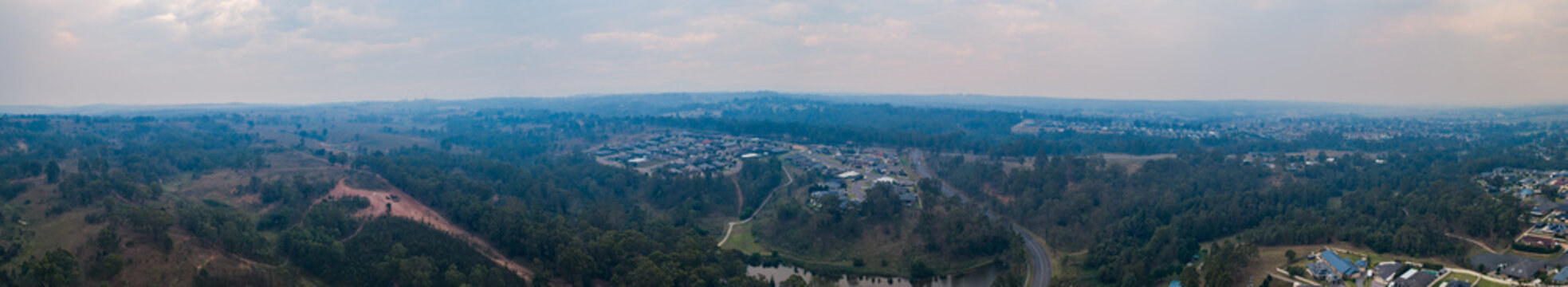 Smoke filled sky over town with distant bushfires burning in australia