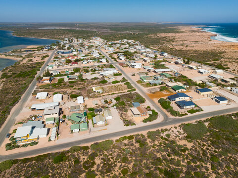 Aerial view of an isolated coastal community on a narrow peninsula