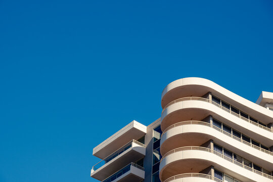 A closeup of an Apartment Building looking up from the footpath with Blue Sky