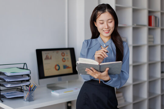 Asian business woman analyzing data in office