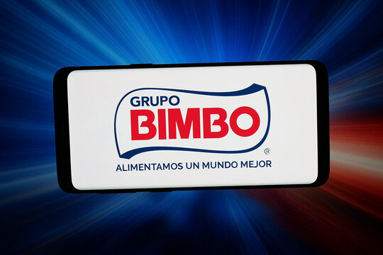 Stuttgart, Germany - 04-16-2026: In this photo illustration, the logo of Mexican food company Grupo Bimbo is displayed on a smartphone in front of abstract background on computer screen.