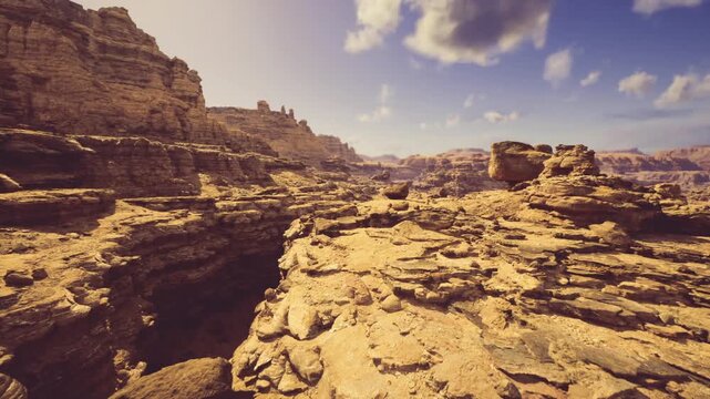 Golden canyon glow bathing sandstone ridges in warm amber light, long shadows across textured ledges, dramatic color contrast and tranquil travel mood at dusk.