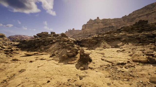 Wideangle canyon floor showing layered beds and scattered stones with sweeping foreground, bright sky and distant spires creating dramatic depth for editorial