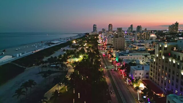 Miami beach iconic night skyline. Miami aerial panorama coastline. Miami south pointe shore dusk. Miami Ocean drive waterfront evening.