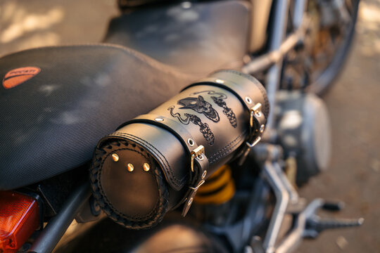 Black leather motorcycle tool bag with skull engraving detail