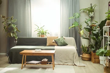 Fotobehang Scandinavisch Wide shot of living room featuring sofa surrounded by indoor plants, presenting biophilic home decor and sustainable lifestyle concept. Supporting interior design, real estate, wellness branding  © Seventyfour
