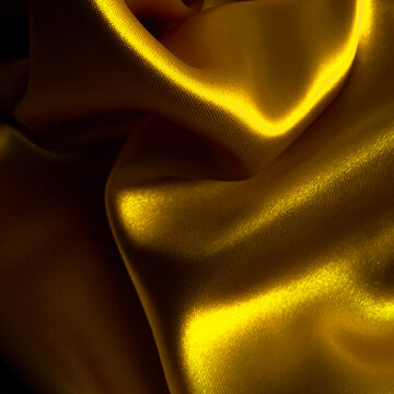 Golden fabric background. Wrinkled cloth