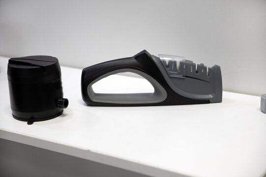 Mechanical knife sharpener. A mechanical device for sharpening knives for the home.