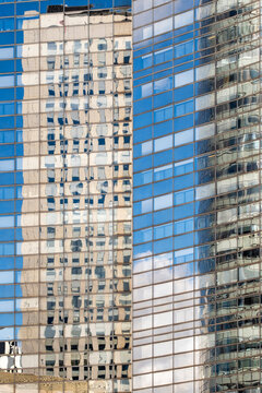 Wavy reflections on blue glass facade creating distortion architecture facade office corporate urban abstract glass pattern modern district surface