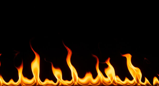 Dynamic burning yellow orange fire flames border spreading horizontally across solid black background hot fiery blaze glowing heat texture element blank copy space