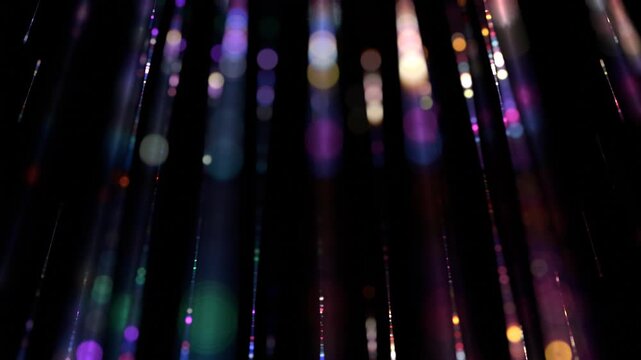 Abstract falling colorful light trails with bokeh background