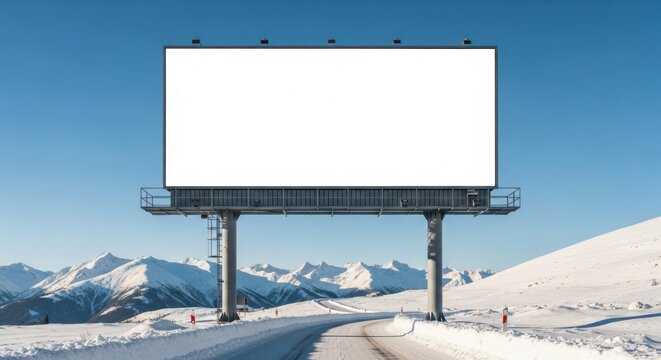 Blank billboard frame on a snowy mountain road with winter landscape and clear blue sky