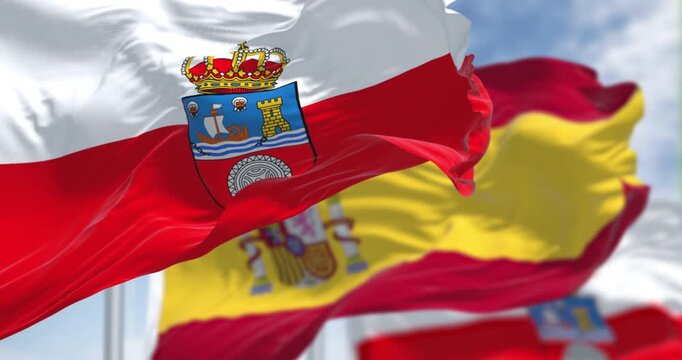 Cantabria flags waving with national spanish flag in the wind. Autonomous community of Spain. Seamless 3d render animation. Slow motion loop. Selective focus