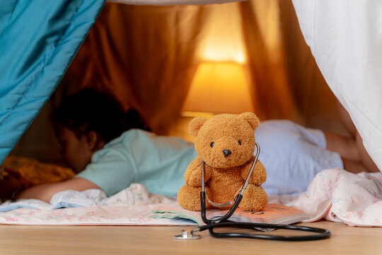 Parents and young child role playing as doctors together at home, representing family bonding and quality time.