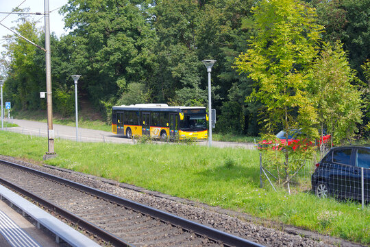 Yellow Swiss Post bus number 540 passing at railway station of Swiss village of Glattfelden on a sunny late summer day. Photo taken September 7th, 2025, Glattfelden, Switzerland.