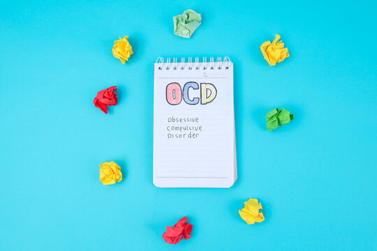 Top View Of Notepad With Colorful OCD Text And Crumpled Papers For Mental Health Concept