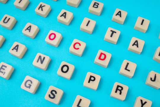 Top View Of Red OCD Letters In Wooden Tiles Standing Out From Grid For Mental Health Concept