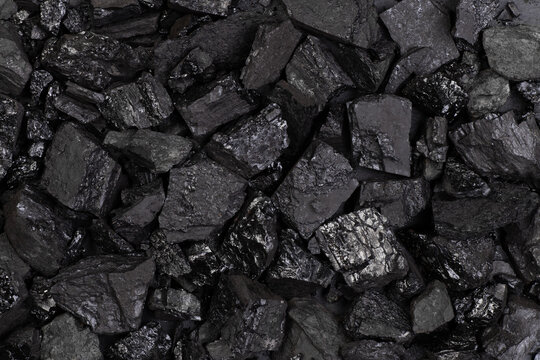 Black lumps of coal background, top view