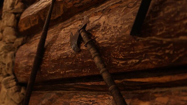 Historical axe mounted on aged log with shadows and textures