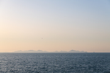Fototapeta premium Distant Mountainous Island Silhouettes on the Blue Ocean Horizon