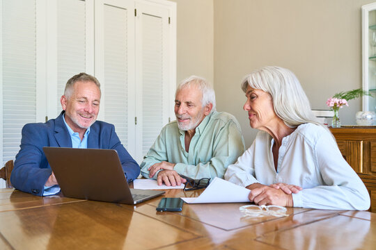 Retirement Planning And Financial Protection: Senior Couple Receiving Professional Advice From Advisor On Laptop For Long-Term Security
