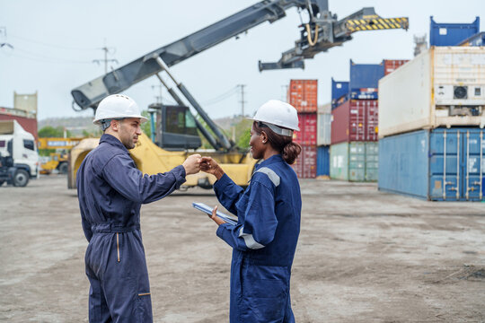 Diverse Logistics Workers Fist Bump at Container Terminal