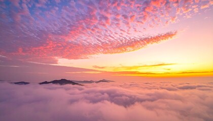 Fototapeta premium A breathtaking aerial view of a vibrant sunset over a sea of clouds.