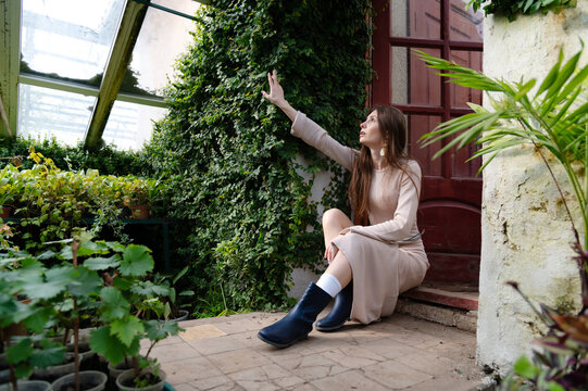 Enjoying time in a greenhouse while examining plants and nature at midday on a sunny day