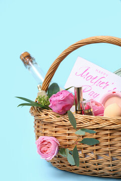 Basket with gifts and peonies flowers for Mother's Day on blue background