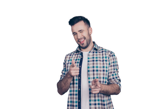 Isolated confident, smiling man in checkered shirt pointing towards his forefingers and winking with one eye to camera over grey background