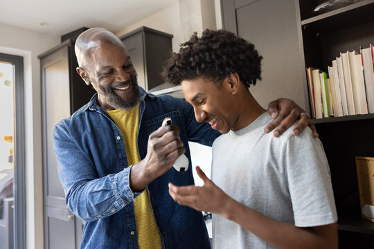 Father giving son car keys for the first time