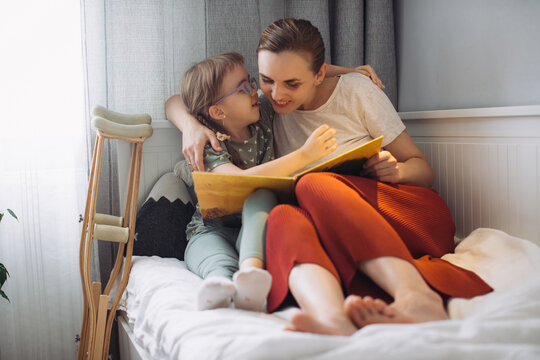 Mother and child reading book, bonding at home