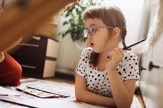 Child with disability learning tracing drawing at home