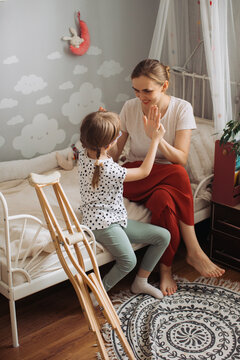 Mother and child playing, facing physical disability challenges