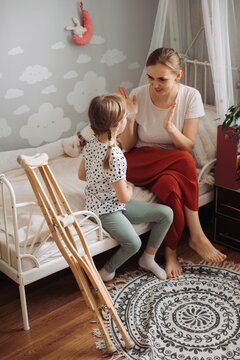 Mother and daughter playing together, disability inclusion concept