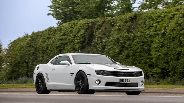 Bicester,Oxon.,UK - Apr 26th 2026:  2012 white Chevrolet Camaro car driving on a British road
