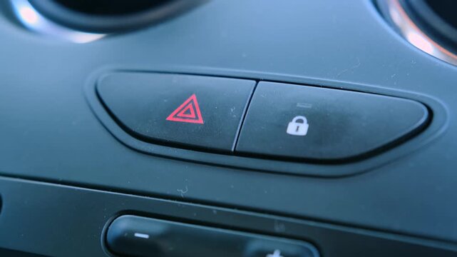 Inside car hazard lights button activated emergency signal system. Red warning triangle illuminated on dashboard control, indicating alert mode, safety signaling, emergency communication in traffic
