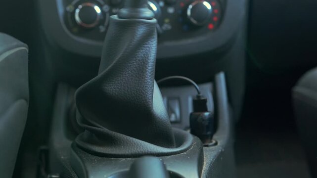 car gear shifting close-up interior shot showing driver moving gearbox into neutral position, manual transmission control during driving process for transport and automotive use