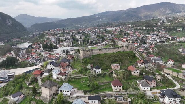 High-angle 4K drone shot of the historic Jajce Fortress and the old town citadel