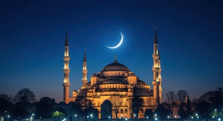 Fototapeta premium Beautiful mosque at night with a crescent moon in the sky