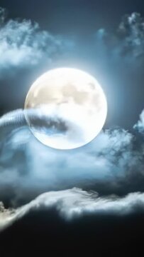 Vertical video: Drifting clouds passing full moon in night sky, curling right veiling face and halo